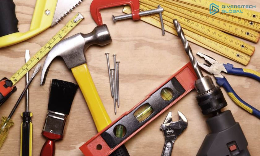 Various tools, including a hammer, drill, paintbrush, and measuring tape, are scattered on a wooden surface. Bright colors and "Diversitech Global" logo visible.