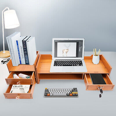 Wooden desk with a laptop displaying a digital art image. Books, a lamp, and a keyboard are present. Drawers hold stationery, creating an organized feel.