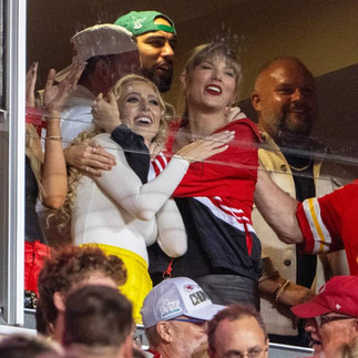 Brittany Mahomes and Taylor Swift cheering and hugging