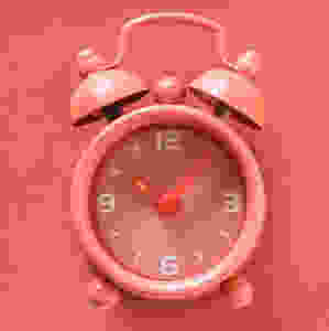 Social media tips with pink alarm clock showing time.