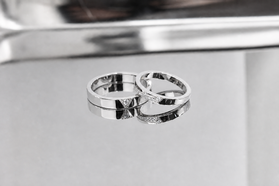 Thumbnail: Yellow gold V Point matching wedding bands with triangular lab diamond accents displayed on a reflective silver surface