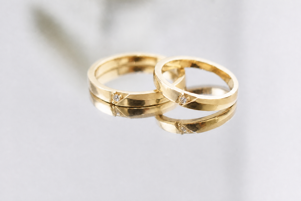 Thumbnail: Stella faceted 14K yellow gold wedding band set with central round lab diamonds, reflective view