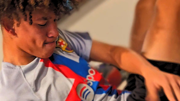 Male working out with a medicine ball at Made Fit By Matt gym facility.