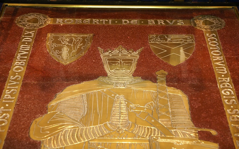 Robert the Bruce's tomb slab of red stone and a gold effigy.
