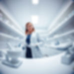 worm-eye view, a female pharmacist, standing in a compounding pharmacy near me