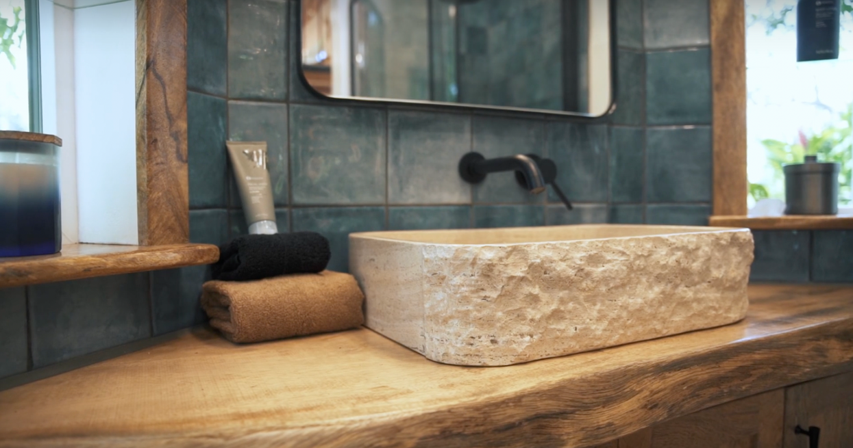 The perfect hand selected local mango wood slab with natural edge overhangs matching mango cabinets below. The care taken to preserve the natural feel of this sultry wood is apparent; you'll find yourself leaning up against it unbothered as you pat your face dry, almost looking for excuses to let yourself brush against it again.
Hawaii real estate, tiny homes, big island, queen model, the queen tiny home by paradise tiny homes and ellie k design, tropical oasis, hawaii luxury home lisitngs, homes and land hawaii for sale, award winning design and architecture, maui, lanai, molokai, oahu, big island