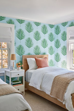 The guest bedroom room of a renovated Hamptons home designed by Britt Design Studio.  The decor is bright and luxurious with an infusion of color and luxury.
