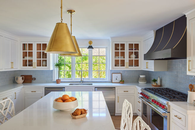 The kitchen of a renovated Hamptons home designed by Britt Design Studio.  The decor is bright and luxurious with an infusion of color and luxury.
