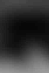 Black and white image of bride and groom outside of industrial Wildman BT.