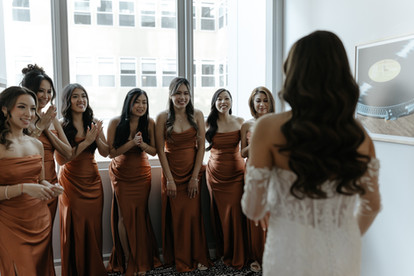 Brides does first look with bridesmaids.