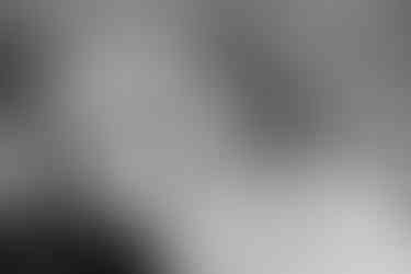 Bride and groom listen to speech at wedding reception.