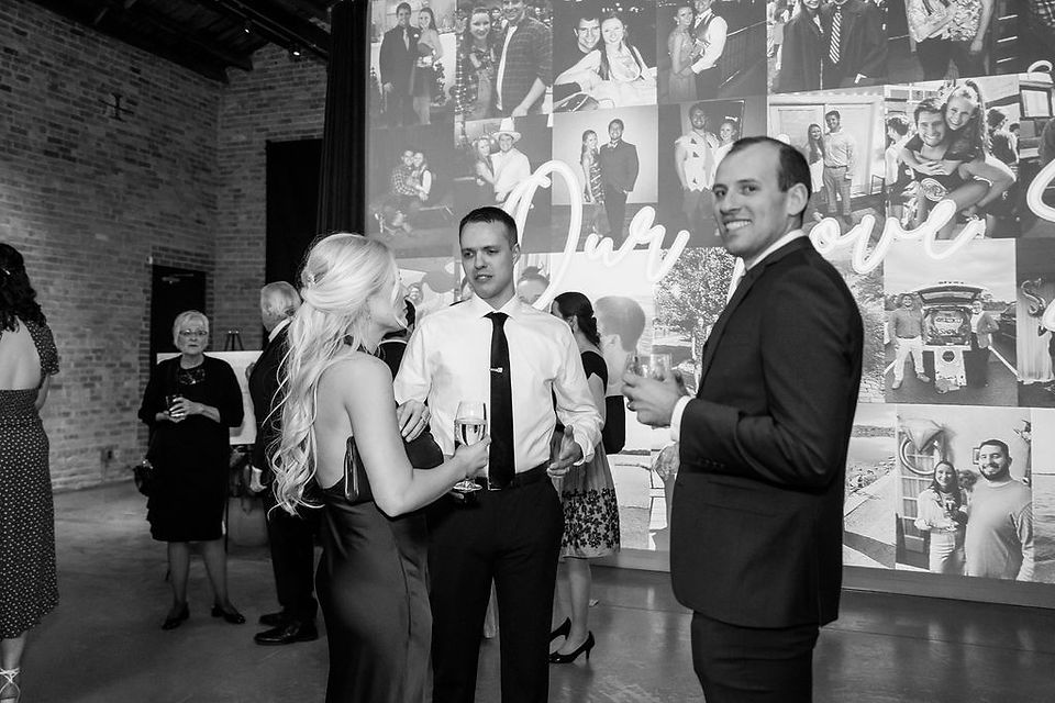 Guests enjoy a drink during cocktail hour in industrial venue.