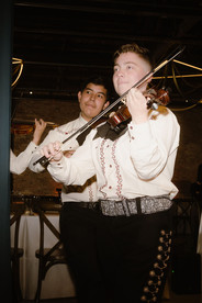 Mariachi musicians performing at wedding reception bringing festive live music to modern Chicago celebration.