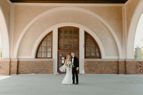 Newlyweds pose outside venue