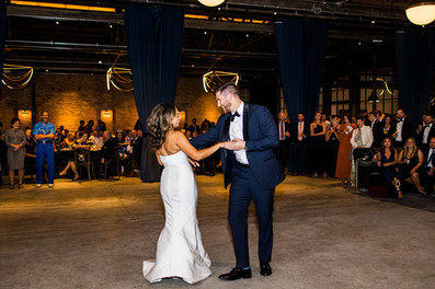 Couple shares first dance beneath lights at Wildman BT.