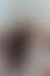 Bride and groom exchanging vows under white draped ceremony arch with red roses at Wildman BT Chicago.