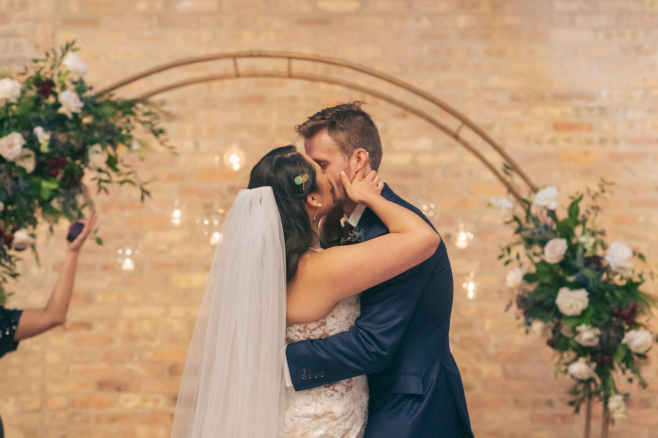 Bride and groom share first kiss as husband and wife.