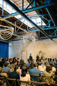 Grooms exchange vows in industrial loft.