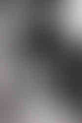 Bride smiling at her reflection in mirror before Wildman BT wedding ceremony.