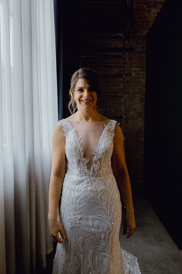 Bride in lace and beaded dress.
