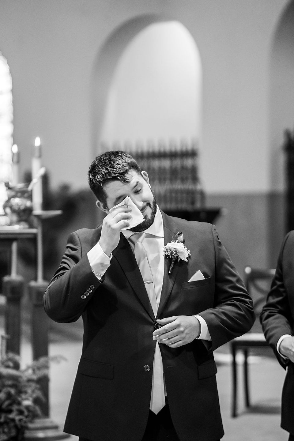 Groom tears up as bride comes down aisle.