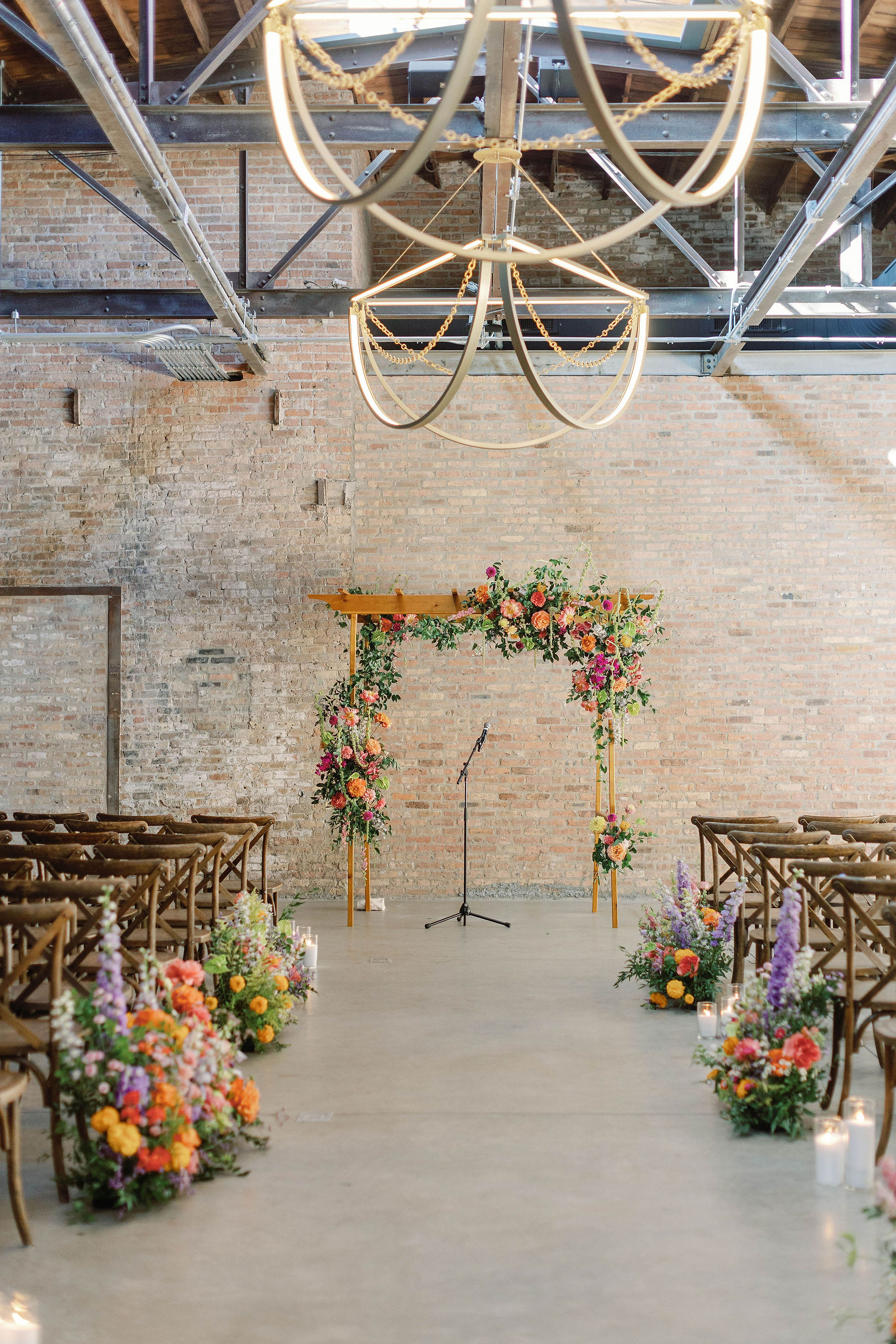 Bright florals accentuate wedding ceremony in a modern loft. a 