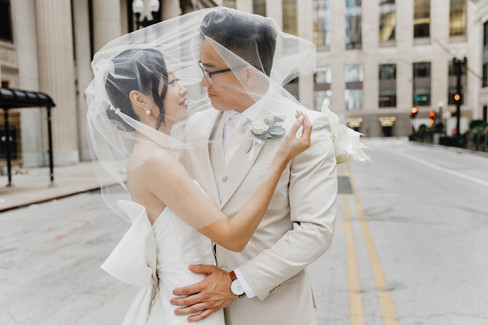 Chic and urban bride and groom in city street.