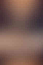 Groom and groom exchange vows beneath chandeliers.