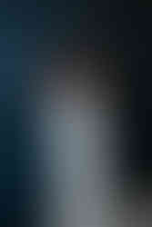 Stunning bride against dark wall. 