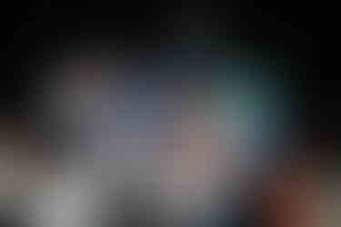 Bride and groom lifted on shoulders by friends during energetic Chicago wedding dance party.