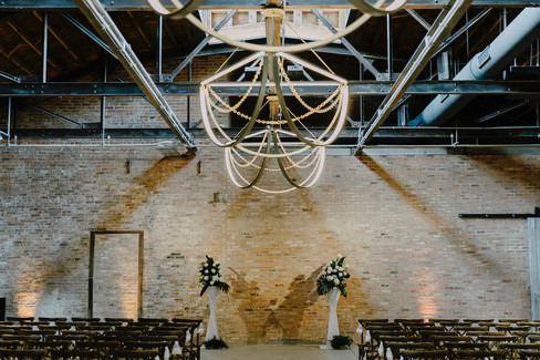 Chandelier and exposed brick at Chicago loft ceremony.