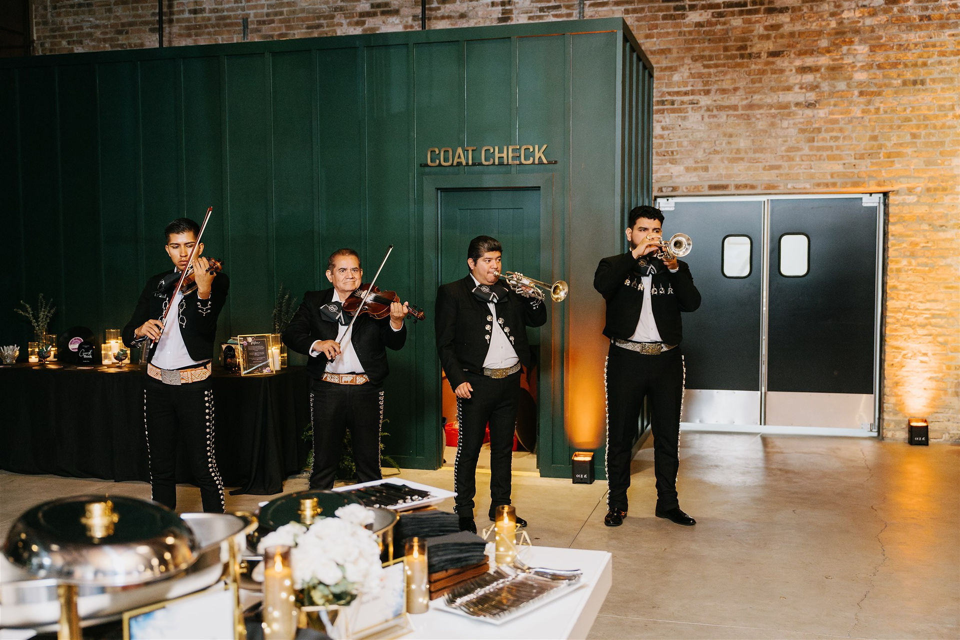 Mariachi band performing during cocktail hour in industrial Chicago venue.