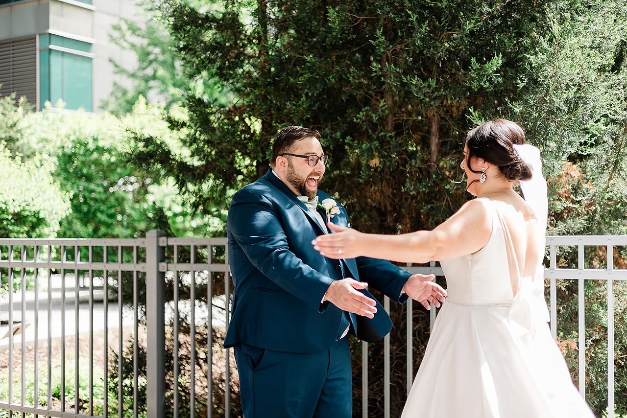 Bride and groom share intimate first-look on Chicago sidewalk.