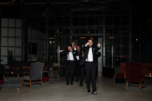 Photo of groomsmen making epic entrance.