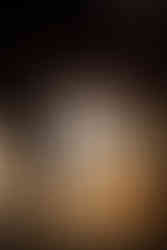 Travel themed Chicago wedding table decor with custom table number, gold accents, and moody candlelit reception details.