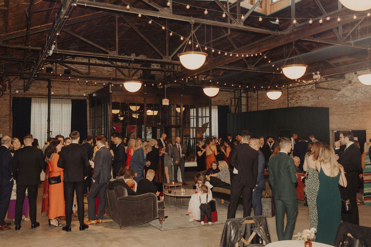 Guests enjoy cocktail hour in chic industrial loft.