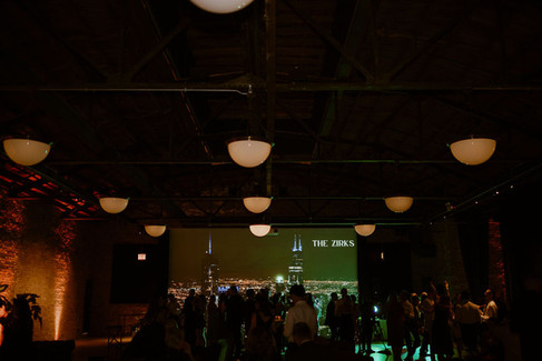 Dimly lit dance floor with Chicago skyline backdrop.
