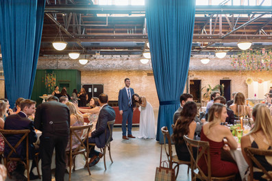 Bride and groom look out over guests.