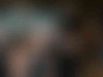 Wedding guests mingling during reception at chic industrial event space.