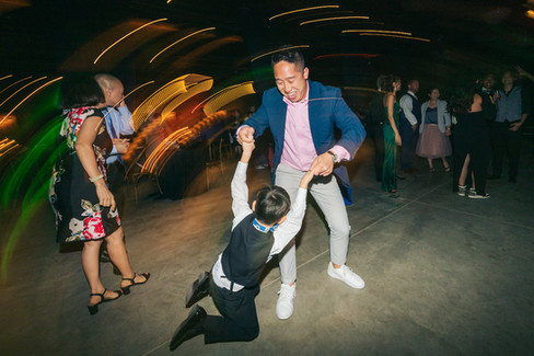 Wedding guest and child dance the night away.