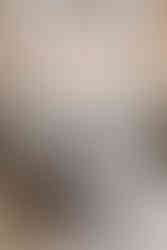 Bride and groom stand before altar at Catholic wedding.