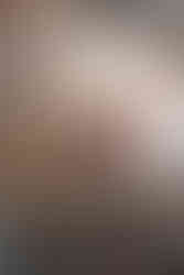 Romantic wedding ceremony setup at Wildman BT with draped white fabric backdrop and red rose floral arrangements.