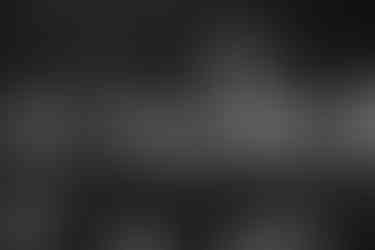 Black and white wedding reception at Wildman BT with guests seated under modern chandeliers.