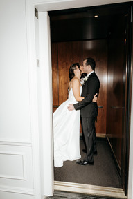 Stylish shot of bride and groom in elevator. 