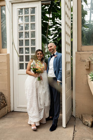 Newlyweds stepping out of door. 