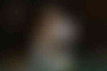 Newlyweds pose for cake cutting