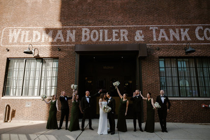 Bride, groom, and wedding parties outside Wildman BT.