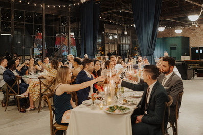 Guests cheer to the newlyweds in loft.