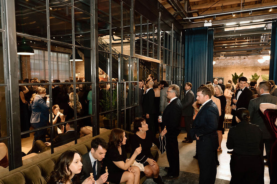 Guests waiting for drinks in industrial loft.