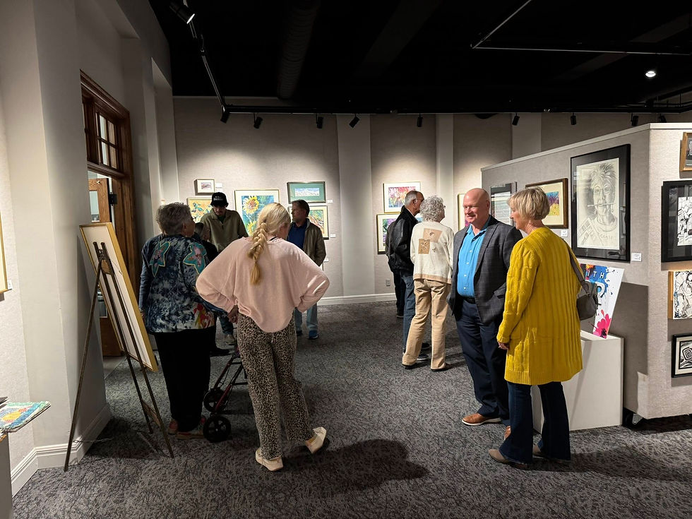 people touring the art gallery open house at the prairie arts center in north platte nebraska